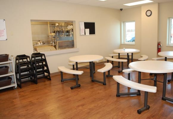 Dining area with tables and chairs in a bright setting