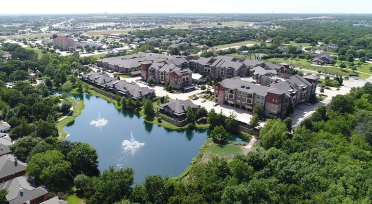 Aerial view of Watercrest at Mansfield with a pond and surrounding greenery.