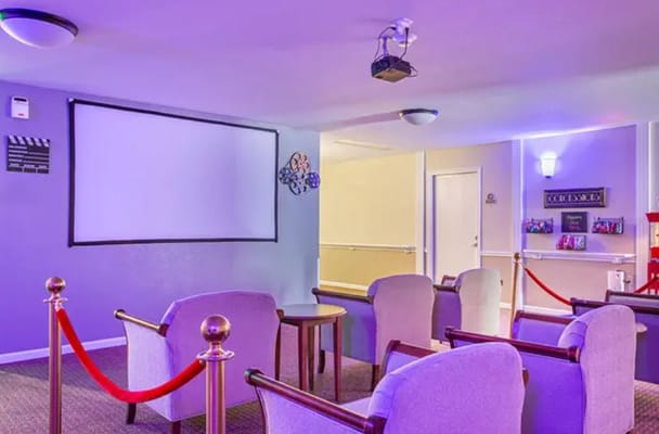 Cozy theater room with seating and a projector screen