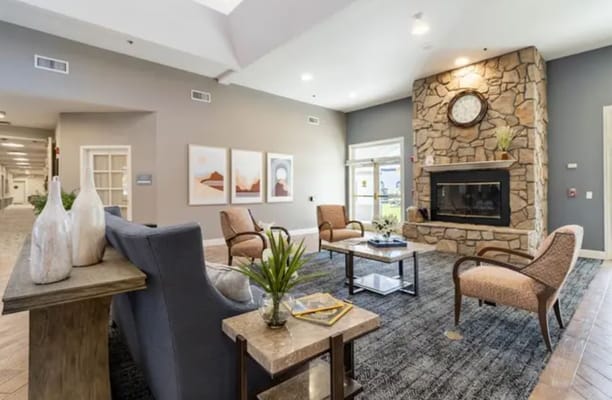 Cozy lobby with seating and a stone fireplace