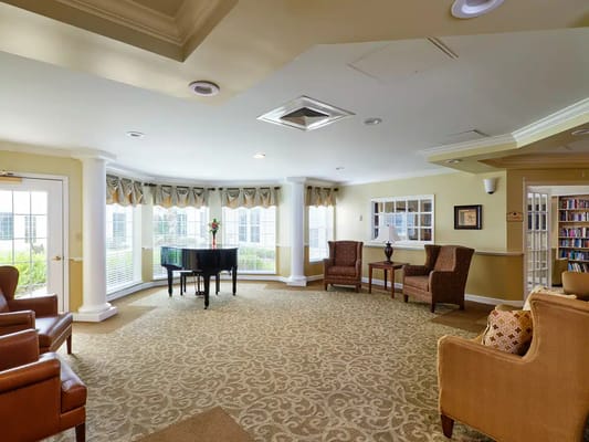 Spacious living room with piano and seating area in Wickshire of Port Orange