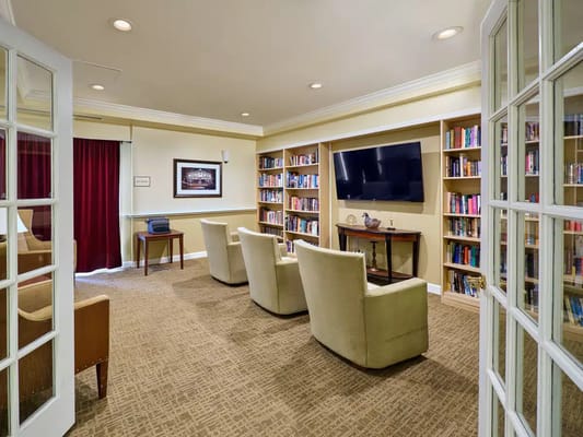 Cozy library lounge with bookshelves and soft seating