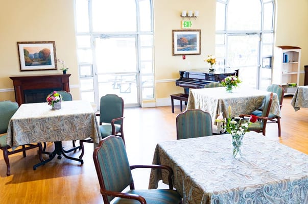 Bright common area with tables and flowers