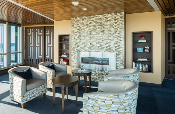 Bright common area with seating and fireplace