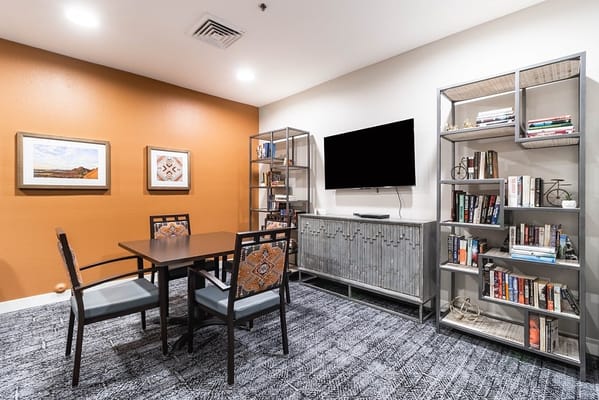 Cozy common area with a table and bookshelf