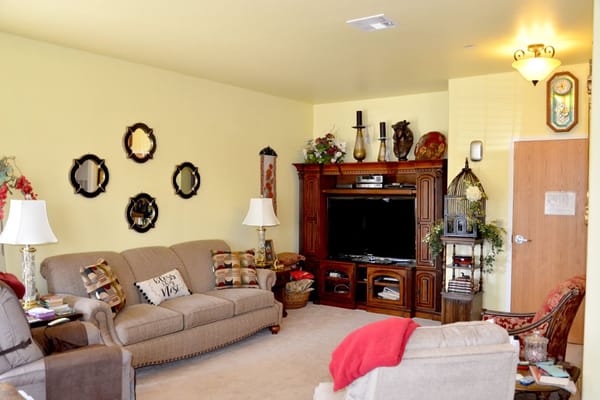 Spacious living room with comfortable seating and decorative elements.