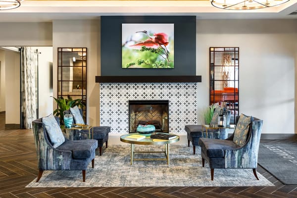 Stylish lobby seating arrangement with a fireplace and artwork