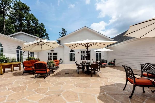 Outdoor patio with seating and umbrellas at The Mann House