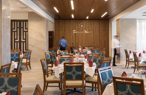 Dining room with well-set tables and staff serving