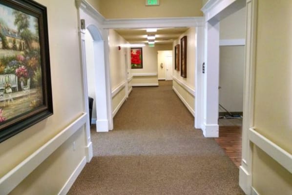 Interior hallway with artwork and carpeting