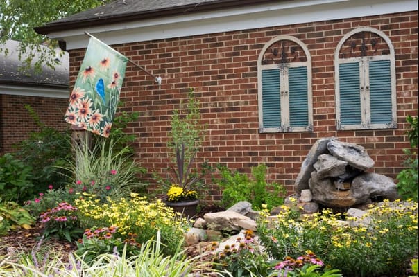 Floral garden area with decorative flag near the facility