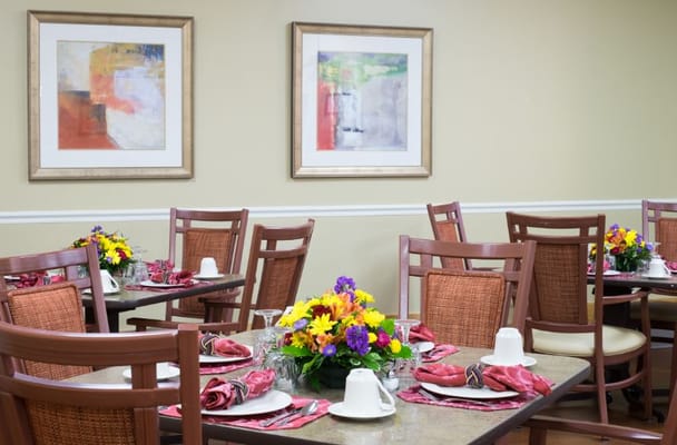 Bright dining room with floral centerpieces