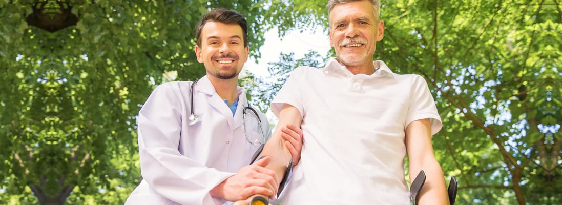 Healthcare professional with a senior resident outdoors