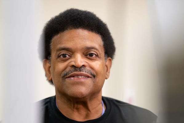 A resident smiling in a bright interior setting