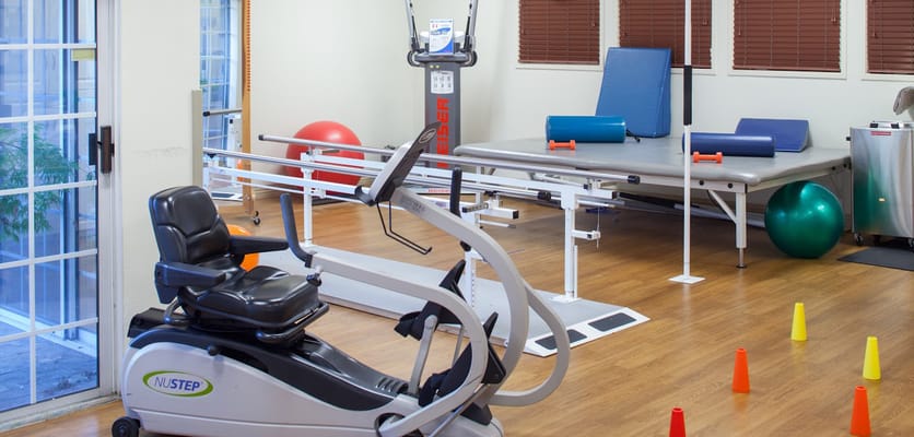 Interior view of a rehabilitation therapy room with equipment
