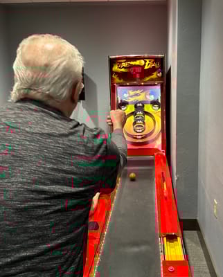 Resident playing a game in an activity room