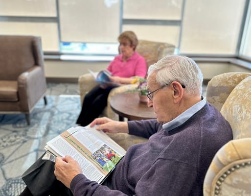 Residents reading in a cozy common area