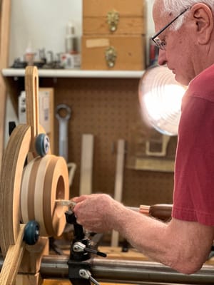 A resident working on woodturning in a workshop