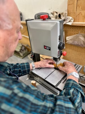 Resident engaging in woodwork inside the facility's workshop