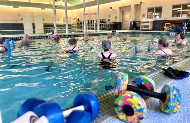 Residents participating in a water aerobics class
