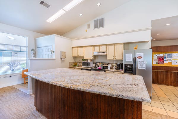 Bright interior common area with kitchen amenities