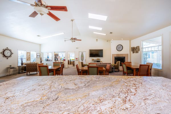 Bright common area with seating and dining tables