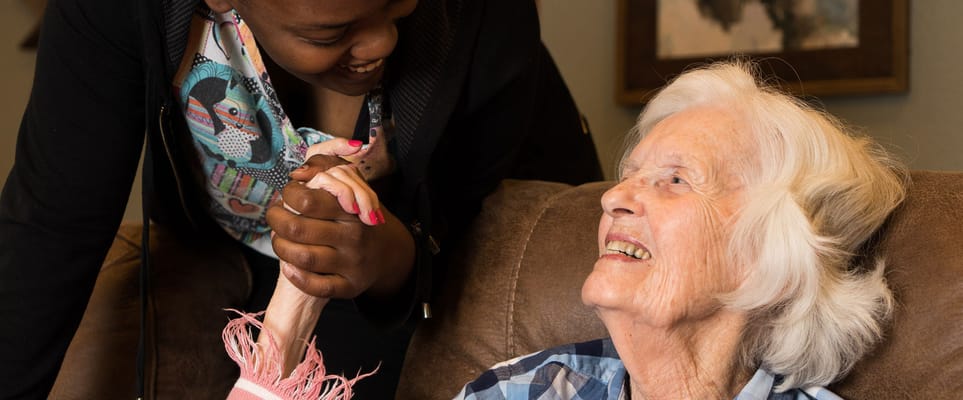 Care staff interacting with a resident in a cozy setting