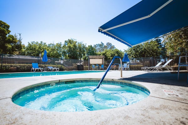 Well-maintained outdoor pool area with lounge chairs