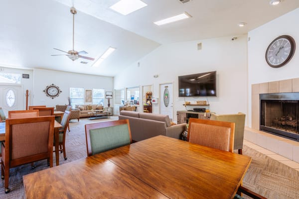 Bright common area with seating and a fireplace