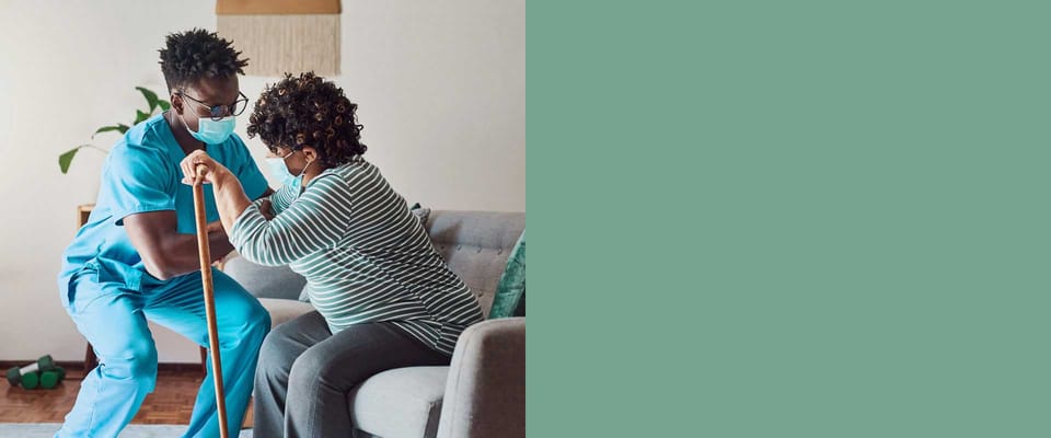 Caregiver assisting a resident in a living room