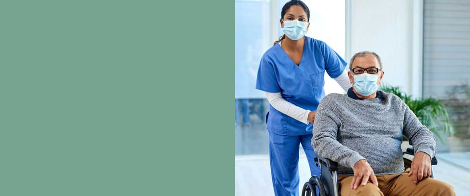 Healthcare worker assisting a resident in a wheelchair