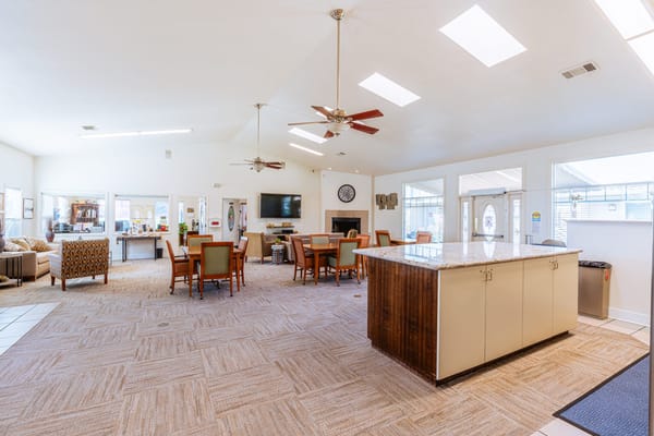 Common area with seating and dining tables in a bright space