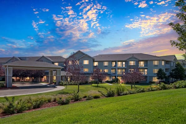 Exterior view of a senior living facility at sunset