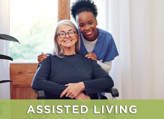 A resident and caregiver smiling together indoors