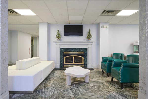 A cozy common area with seating and a fireplace