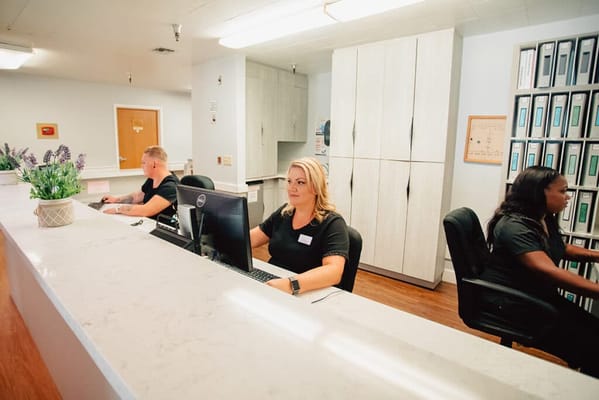 Staff members working at the reception desk