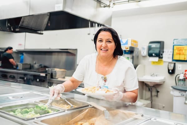 Staff serving food in the dining area