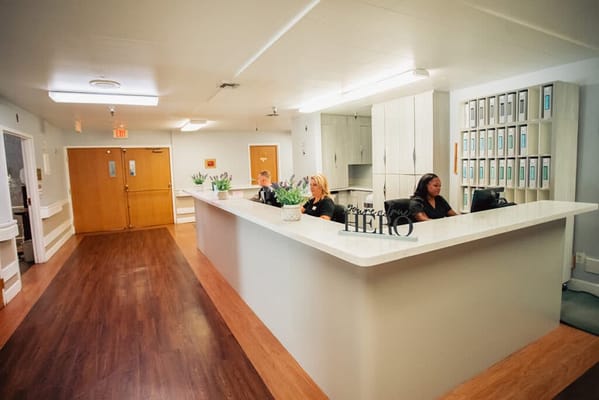 Reception area with staff at the front desk