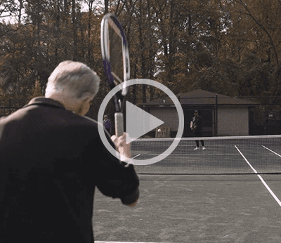 Seniors playing tennis on an outdoor court
