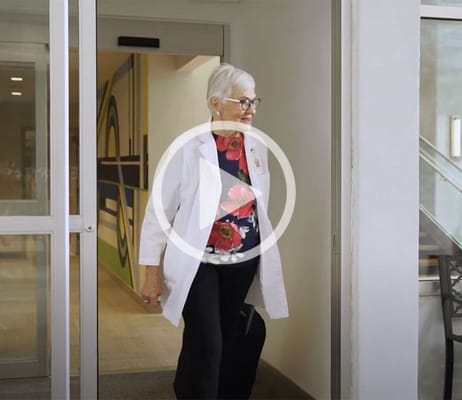 Resident walking through an interior hallway