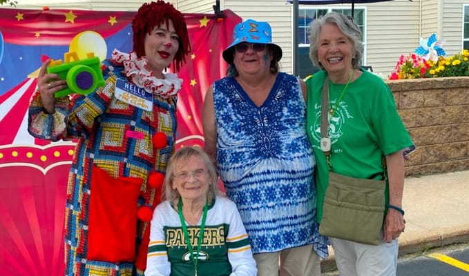 Residents enjoying a carnival-themed event with a clown
