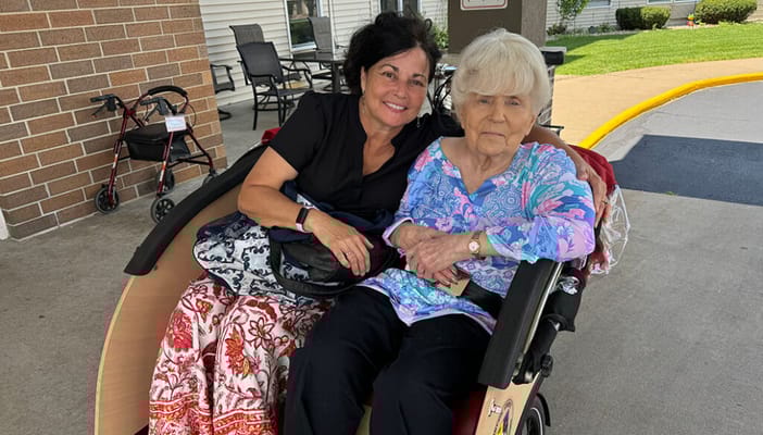 Staff member with senior resident outdoors