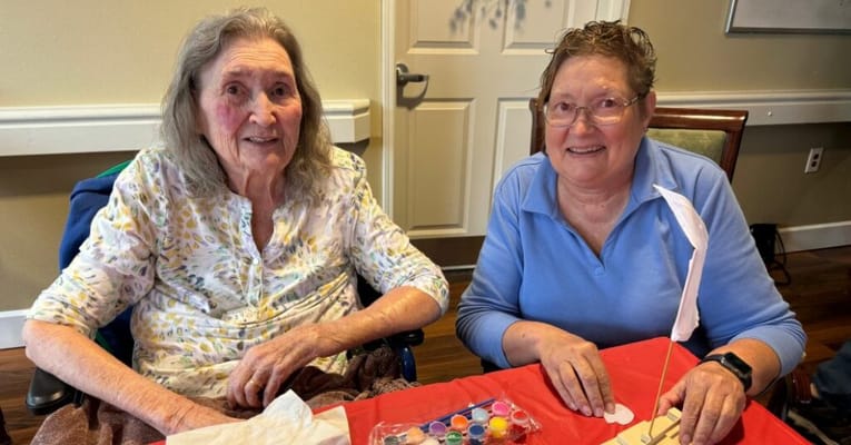 Two residents engaged in an activity at a table