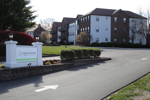 Exterior view of Cedar Woods facility with signage