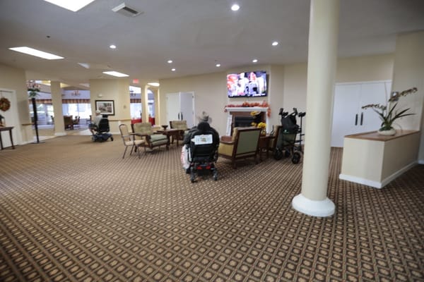 Residents in mobility scooters in a common area