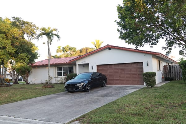 Exterior view of Coral Springs AFCH with a black car