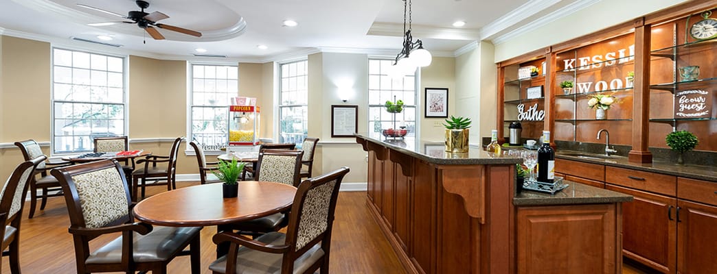 Cozy common area in a senior living facility with tables and decor