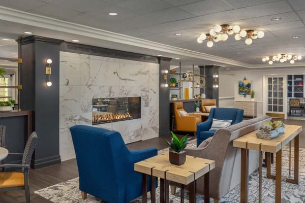 Bright interior common area with seating and fireplace