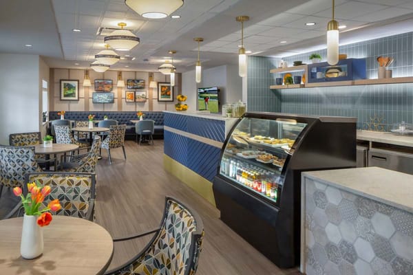 Bright interior common area with seating and food display