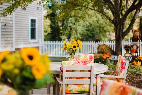Outdoor seating area decorated with sunflowers